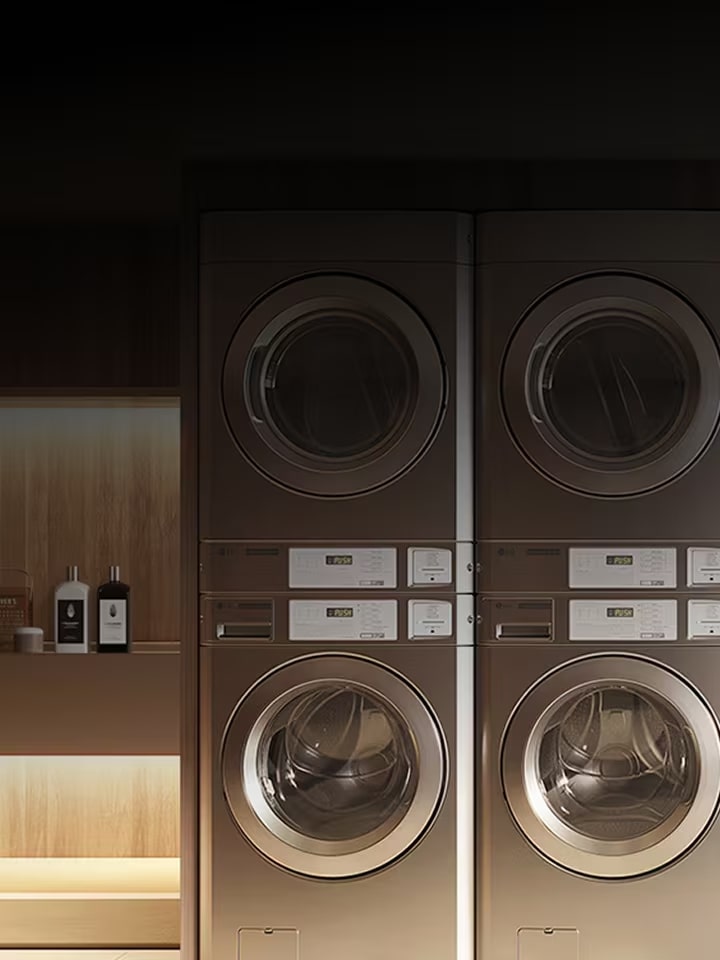 Premium commercial laundry setup with stacked washers and dryers in a dark, refined interior