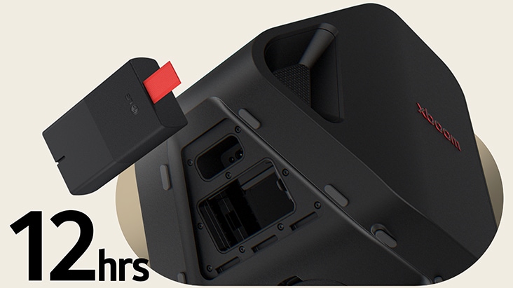 Rear side of Stage 301 is shown with its battert part open. A replaceable battery is hanging on the air right next to the xboom Stage 301.