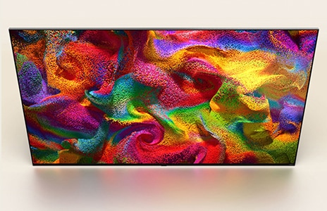 منظور علوي مائل لتلفزيون LG QNED TV مع عمل فني تجريدي ملون على الشاشة.