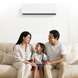 A mother and her daughter are hugging each other, wearing big smiles on their faces.