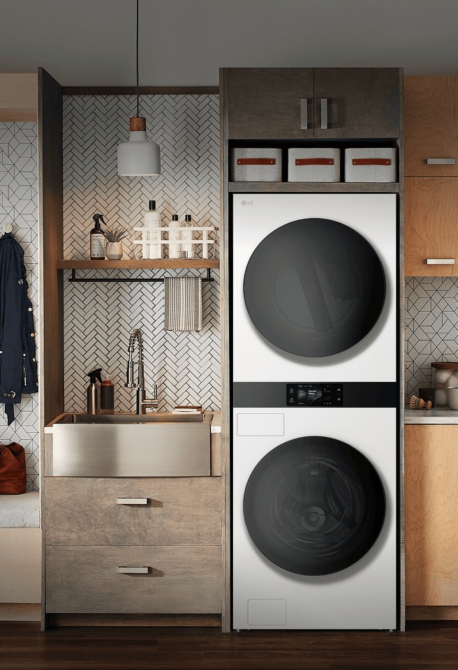 LG built-in stacked washer and dryer in a modern laundry room with wood cabinetry and bench seating