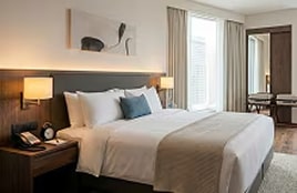 Hotel room showcasing integrated in-room technology and a comfortable hospitality experience