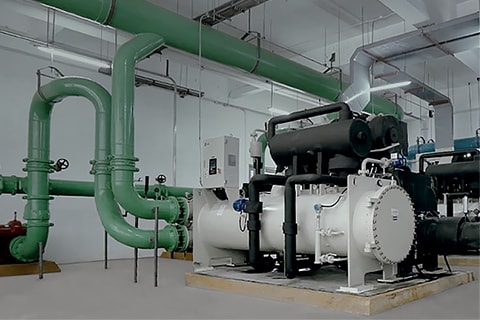 Large-scale industrial HVAC equipment and complex piping system inside a facility for optimized industrial operations
