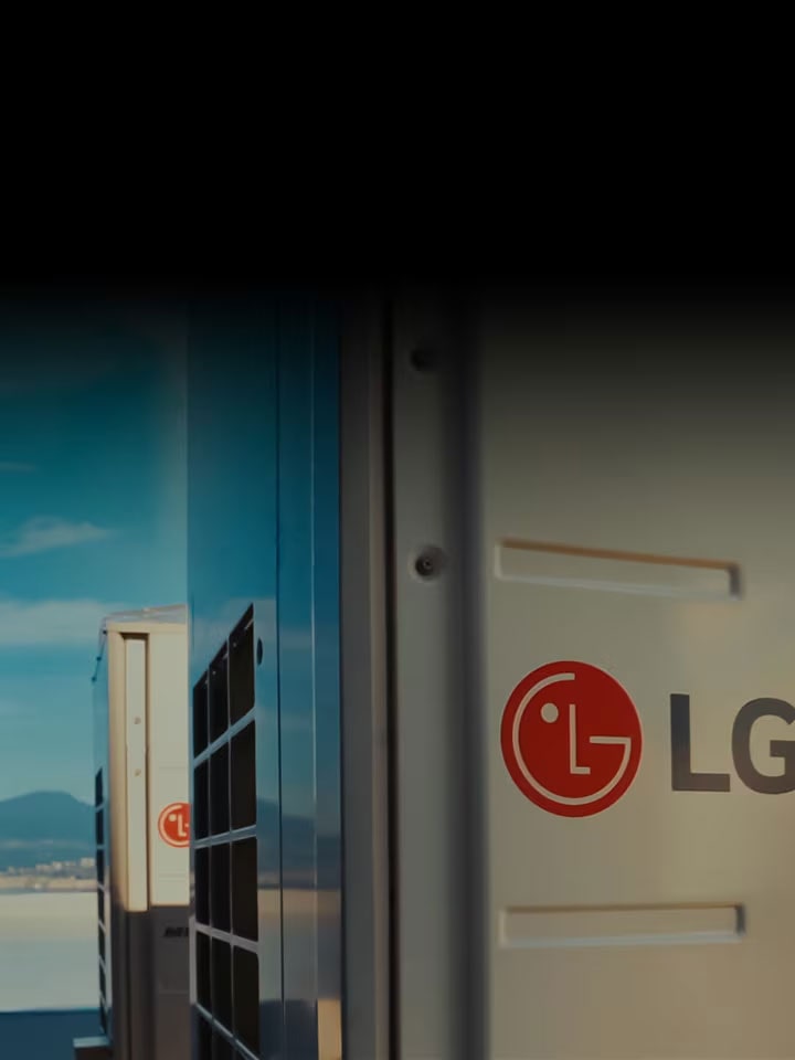 LG HVAC outdoor unit installed with LG logo in focus against a clear sky. Efficient and sustainable climate control technology for all environments.