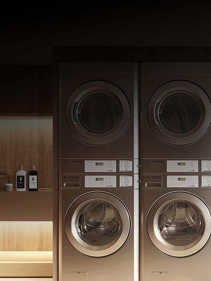 LG Smart Laundry Lounge with stacked commercial washers and dryers alongside wardrobe-style appliance, text overlay LG Smart Laundry Lounge