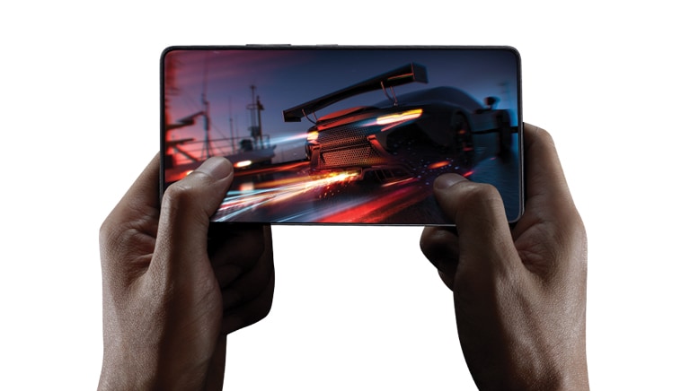 Close-up image of a hand playing a car game on a mobile phone.