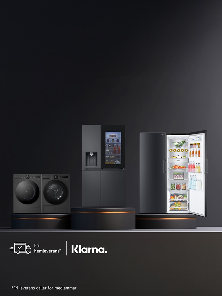 Bilden visar en grupp eleganta, svarta **LG-vitvaror** placerade mot en mörk bakgrund. Till vänster syns en stor frontmatad tvättmaskin bredvid en matchande torktumlare. I mitten står ett högt kylskåp, och till höger finns en diskmaskin med öppen lucka där man kan se prydligt placerade korgar och disk inuti. Designen är modern och stilren och framhäver LG:s premiumkänsla.