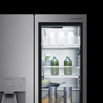 The LG SIGNATURE Refrigerator with lit glass door allowing you to see inside.
