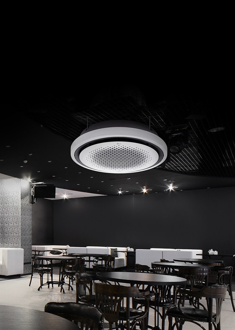 Black and white tone dining area with tables, chairs, and a sofa displayed. LG Round Cassette air conditioner(ac) mounted on the ceiling. 