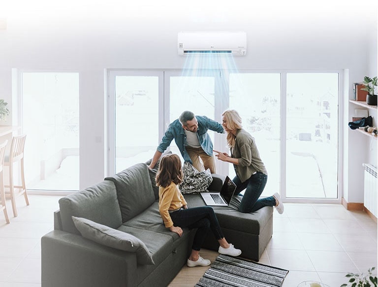 A joyful family, father mother and a young daughter, is having a conversation on a living room sofa, LG hvac wall-mounted air conditioner(AC) providing cool comfort to all.