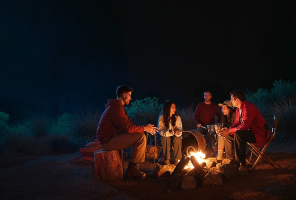 People enjoying camping with smiles, embracing the power of optimism.