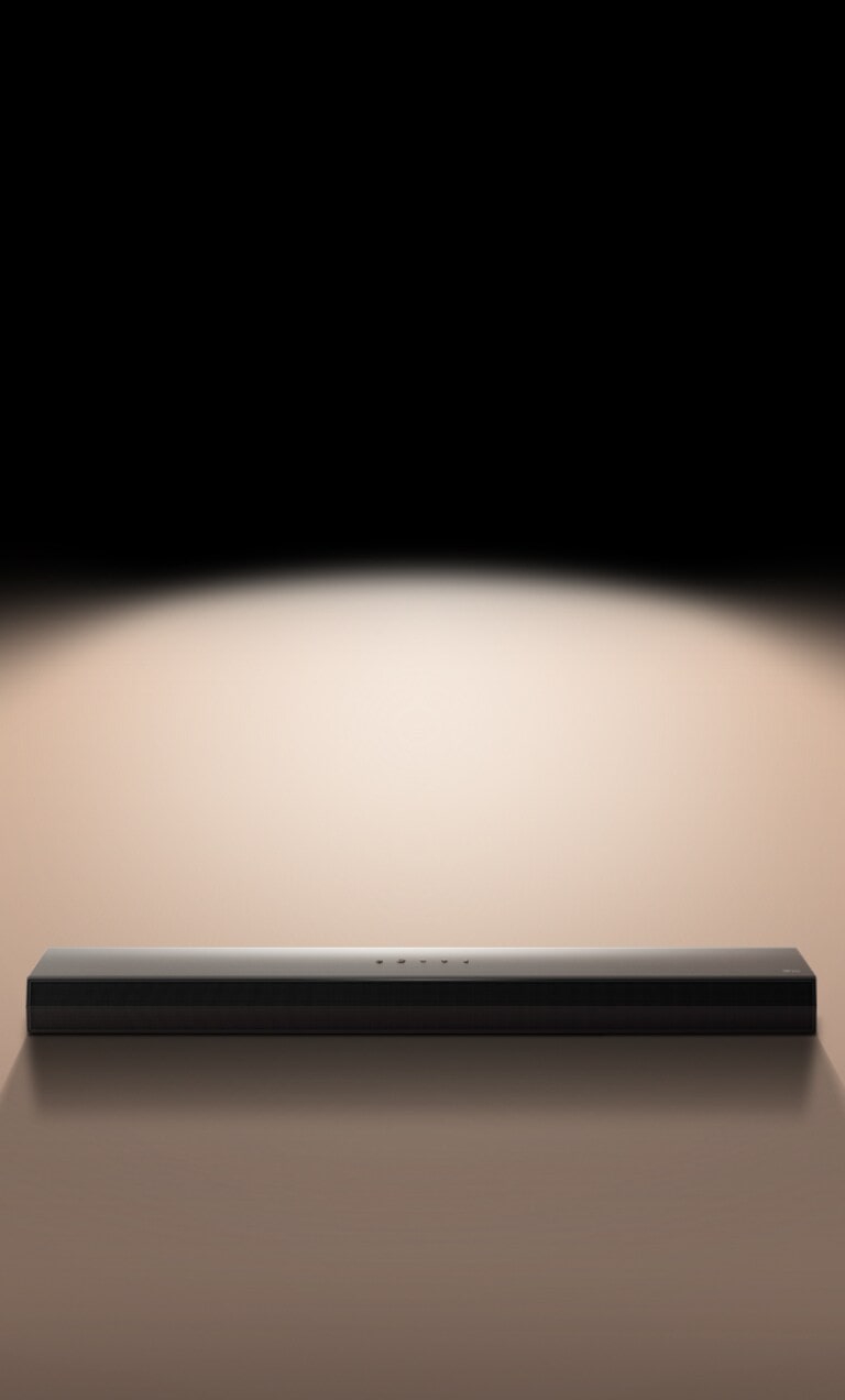 يظهر مكبر الصوت LG Soundbar على خلفية سوداء مظللة بضوء موجَّه.