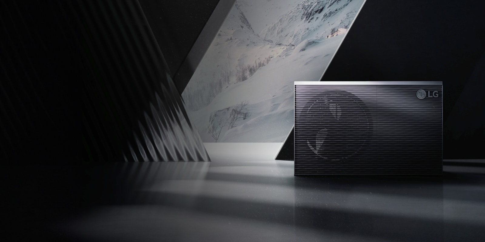 A black LG THERMA V  product is placed in front of the snow mountain screen.