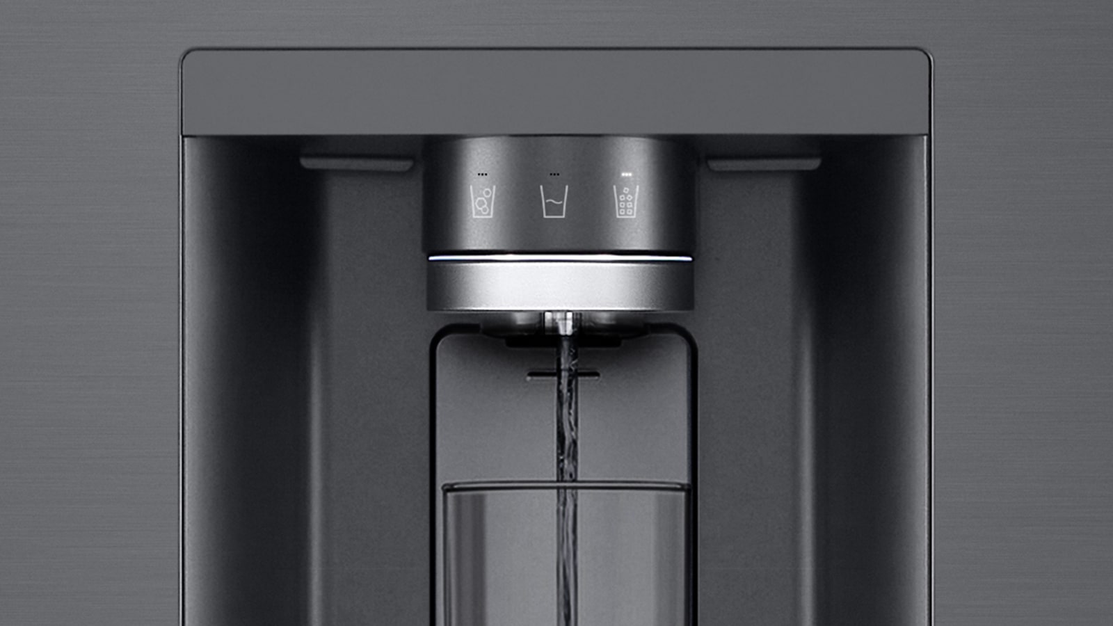 A video starts zoomed in on the water dispenser. The exterior of the refrigerator goes clear and now the interior of the door and mechanical parts of the dispenser nozzle can be seen. The video zooms in further to show the water droplets as they fall through the UVnano part of the nozzle which reduces the bacteria. The view zooms back out to see the exterior of the refrigerator again as water is being dispensed into a glass.