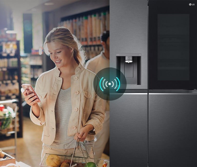 A split screen image of a women in a supermarket with a mobile phone. The woman is communicating with her fridge at home in the kitchen while she is doing the grocery shopping. Above the fridge is a wireless remote icon.