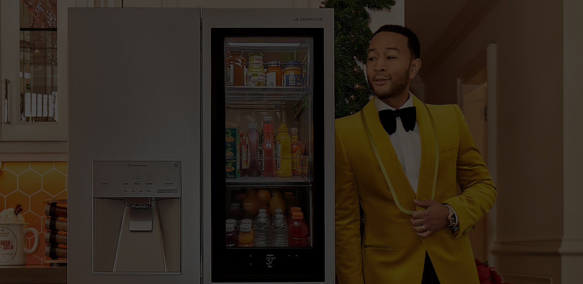 Singer John Legend leaning on an LG SIGNATURE Refrigerator.