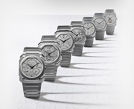 Seven silver BVLGARI watches arranged in a diagonal line.