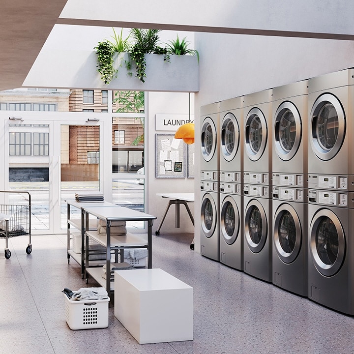 Modern self-service laundromat with rows of commercial washers and dryers in a clean, bright space