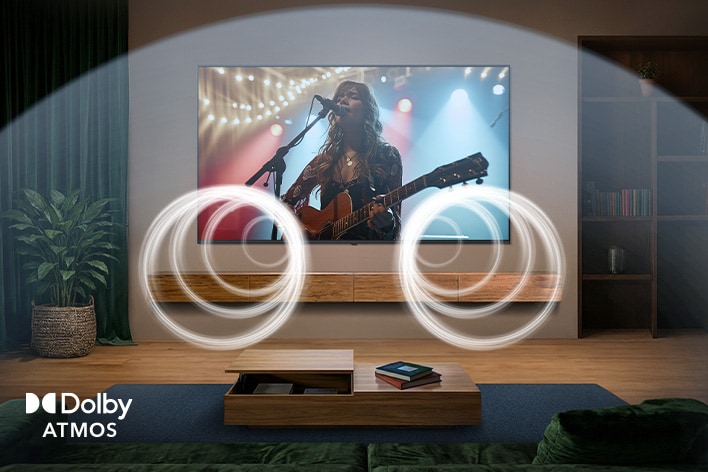 LG QNED evo AI QNED85 Mini LED with Dolby Atmos shows an artist performing live acoustic music on screen in a living room, with visualized sound waves surrounding the space to indicate immersive, multi-directional, object-based audio.