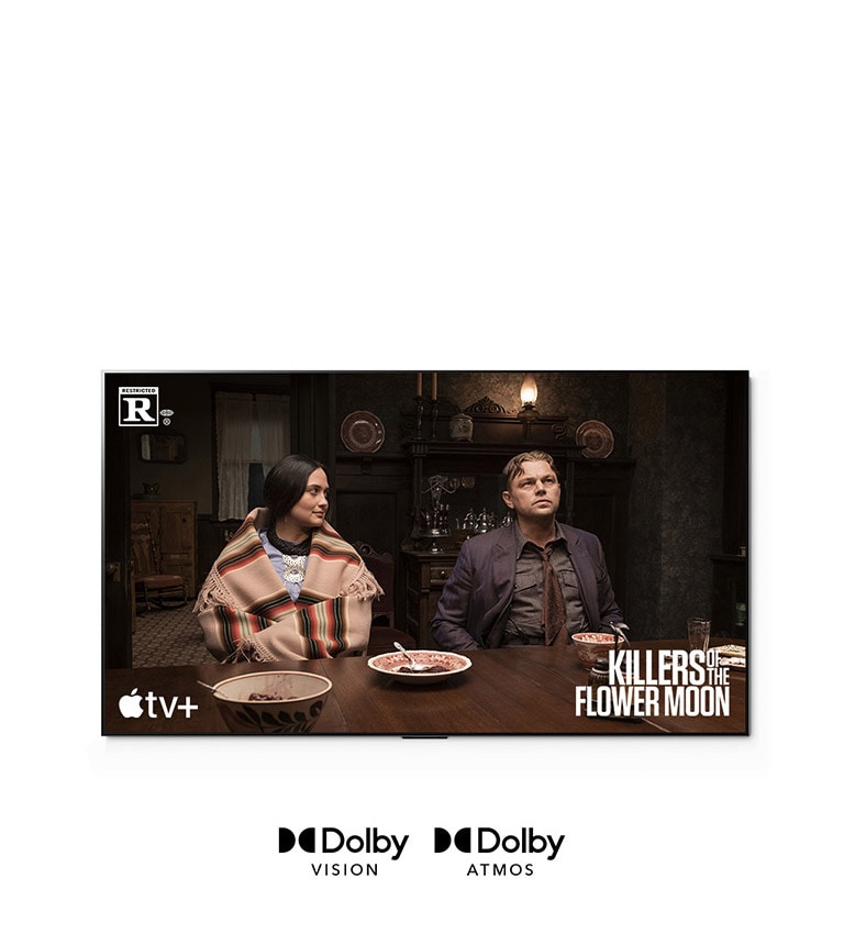 Bild eines Mannes und einer Frau, die zusammen am Tisch sitzen – Filmszene aus „Killers of the Flower Moon“.