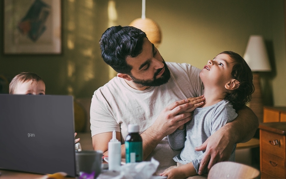 A father and child use telehealth as assistive technology.