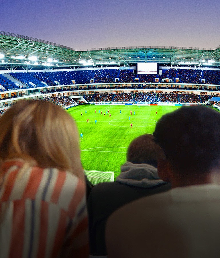 People are watching a football game, with a backdrop of the entire stadium, on a large TV (scroll down the page)