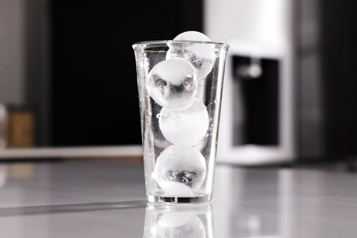 Clear glass filled with round craft ice made in an LG refrigerator