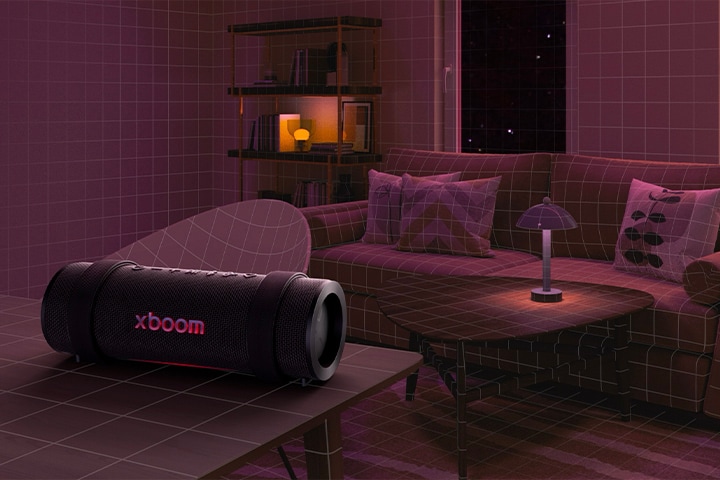 In a room filled with a pink lighting white sofa and table are placed behiind. In the fornt, xboom Grab is placed on the top of white rectangular table.