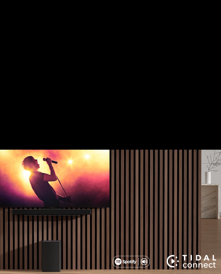 Sound bar and TV are placed on the white table and 7 white horses are shown on the TV.