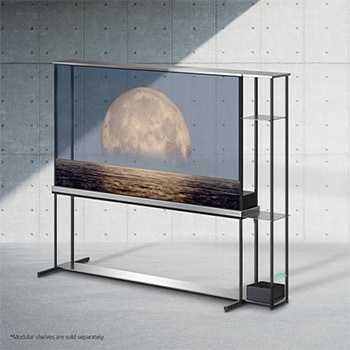 Slightly-angled left-facing side view of LG SIGNATURE OLED T screen depicting a moon above shore on a transparent screen. Zero Connect Box with 4K 120Hz wireless video & audio transfer connected to the TV sitting on an attached modular shelving unit, and a WiFi signal coming out of the box.