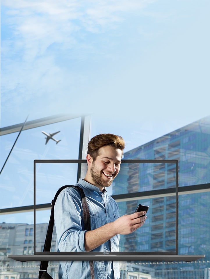 Man looks at phone in city environment. LG gram laptop appears on screen. 