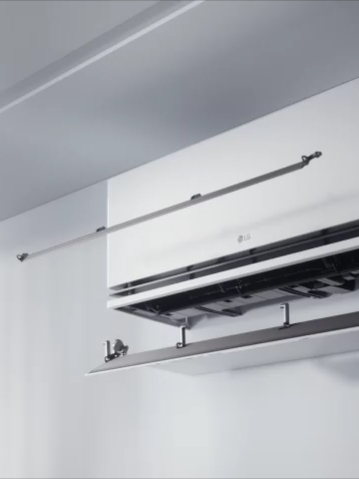 LG air conditioner with dual vane technology directing airflow for enhanced cooling and heating efficiency.