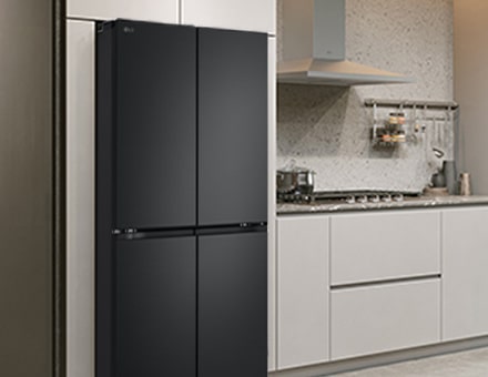 Modern kitchen interior with stainless fridge.