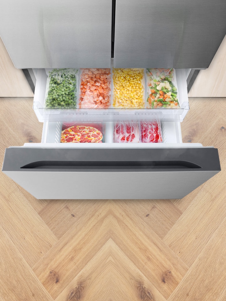 LG freezer drawer opened with meat and vegetables displayed.