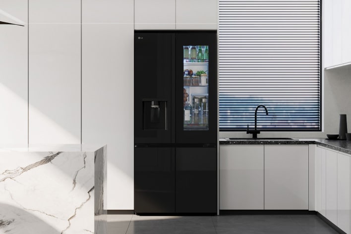 A modern kitchen reflected in the sleek design of the lg french door refrigerator with black mirror doors.