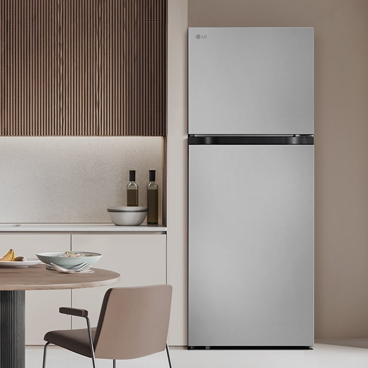 LG top freezer refrigerator is in modern kitchen, showcasing overall design of the refrigerator.