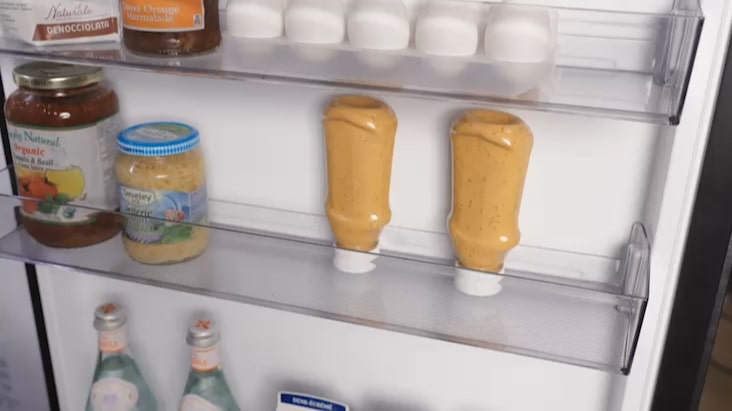 LG Fridge Freezer door with mini baskets holding sauces, jars, and beverages. LG Fridge Freezer door with mini baskets holding sauces, jars, and beverages.