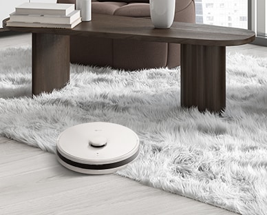 Image of a robot vacuum cleaning the floor and carpet.	