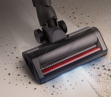DUAL Floor Max™ Nozzle vacuuming dirt on a hard floor surface.