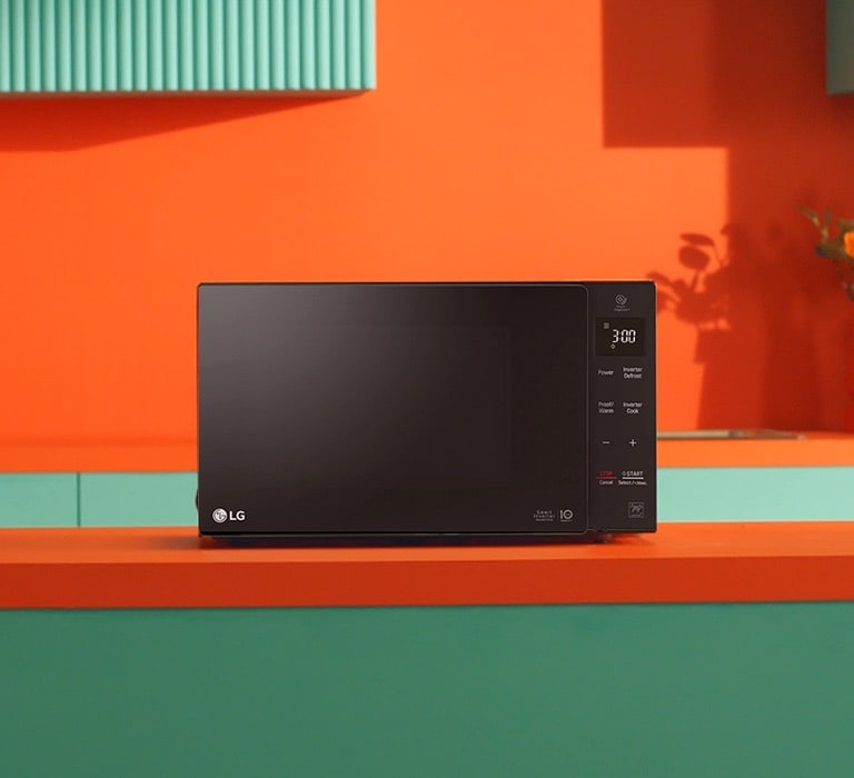 LG Neochef® microwave oven placed in bright orange and green modern design kitchen.