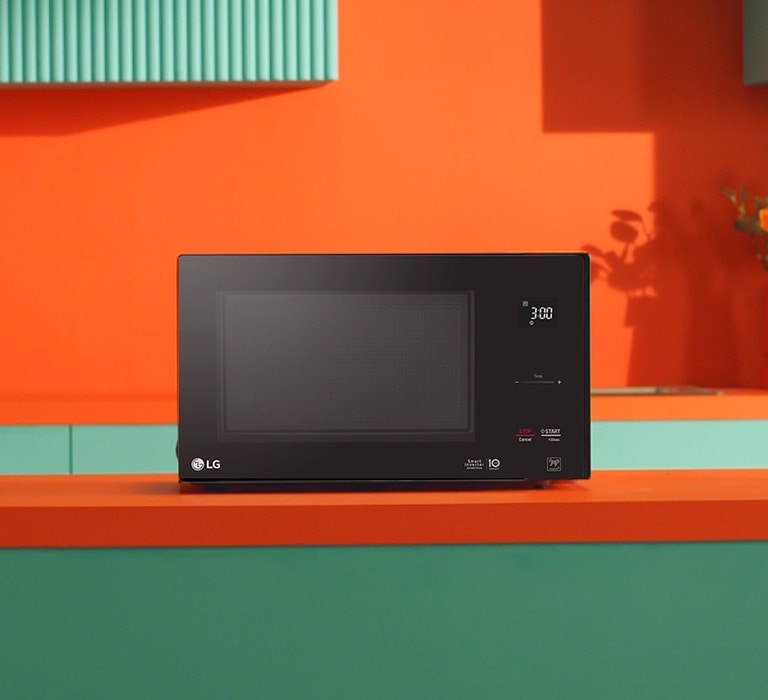 LG Neochef® microwave oven placed in bright orange and green modern design kitchen.