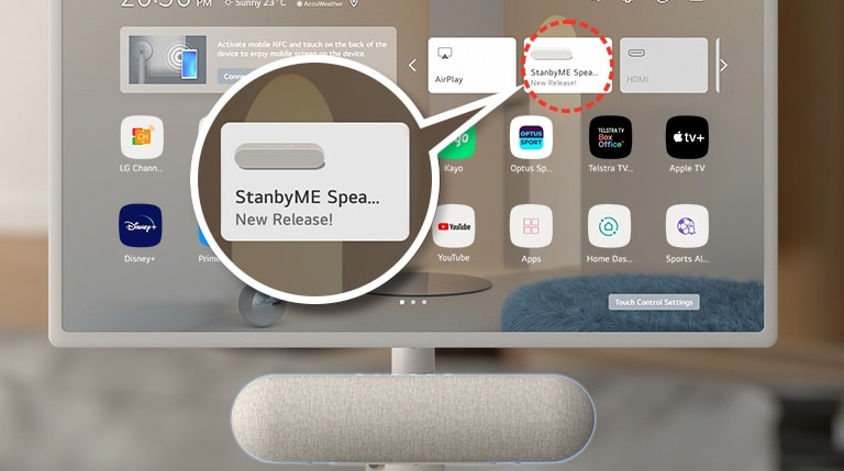 Close-up of the LG StanbyME screen. The XT7S speaker is attached at the bottom. The screen shows a home screen with the speaker's exclusive widget highlighted. To highlight the app, an enlarged image of the StanbyME speaker widget is also shown.
