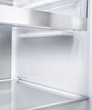 A diagonal view of the shelf with metallic paneling on the interior of the refrigerator.