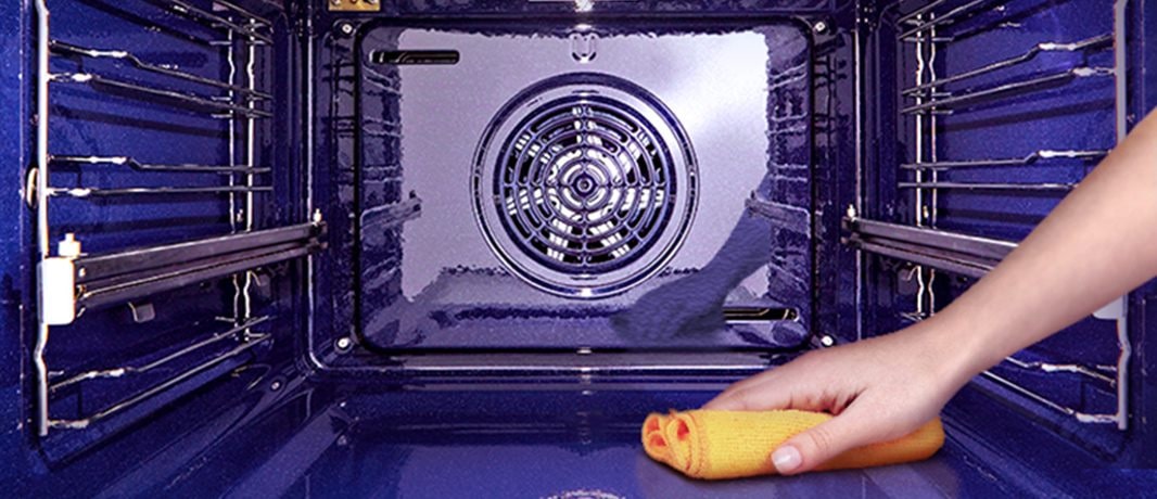 The image of wiping the inside of the oven with a cloth.