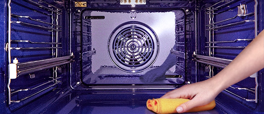 The image of wiping the inside of the oven with a cloth.