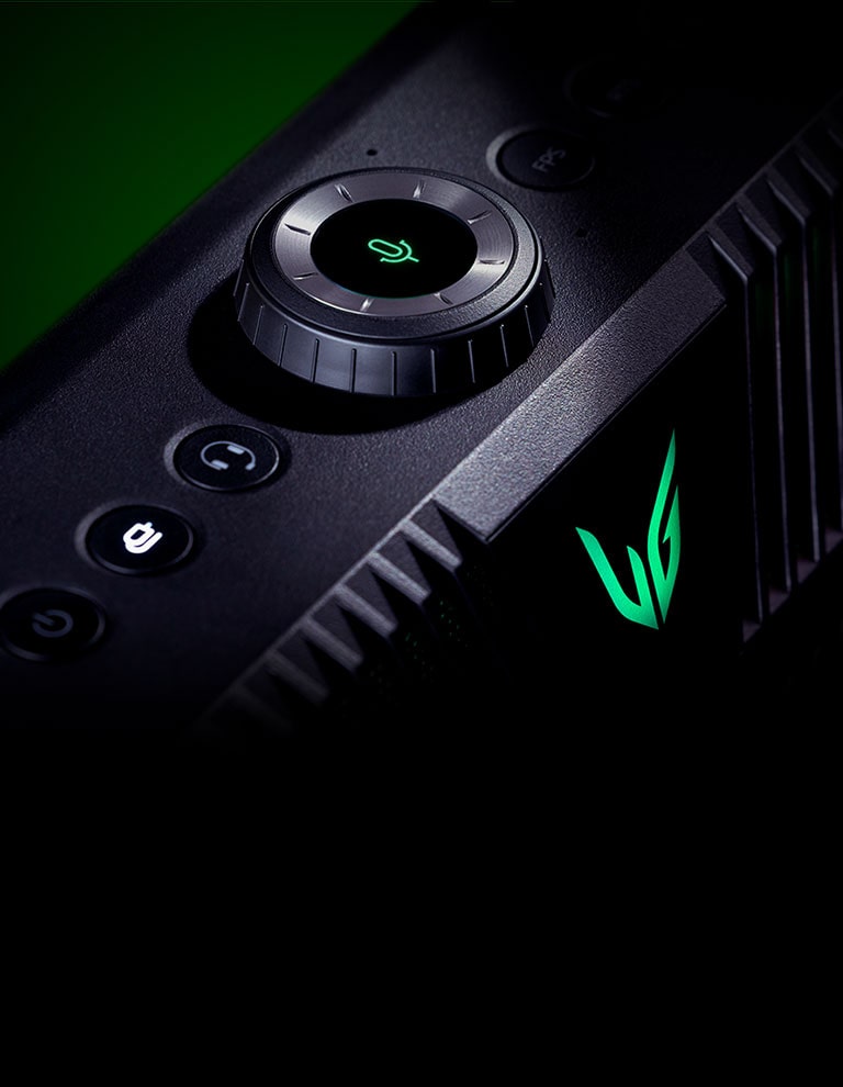 A diagonal view of gaming speaker from top - highlighting the MIC button on its top and there is a green lighting effect behind.