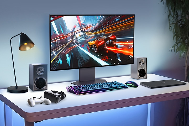 A 32-inch gaming oled monitor is positioned in the center of the desk, with various IT devices placed around it.