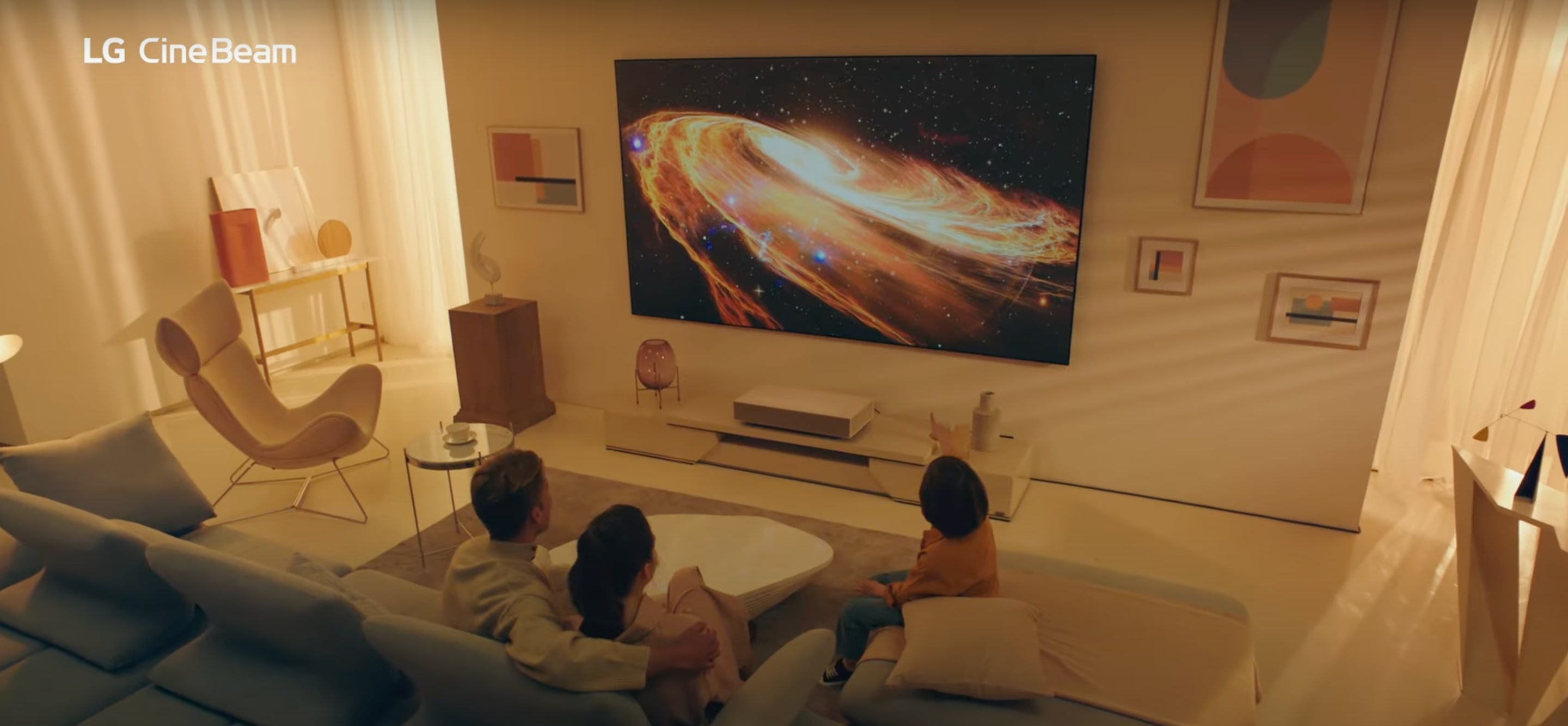 A group watch TV in a modern lounge space. 