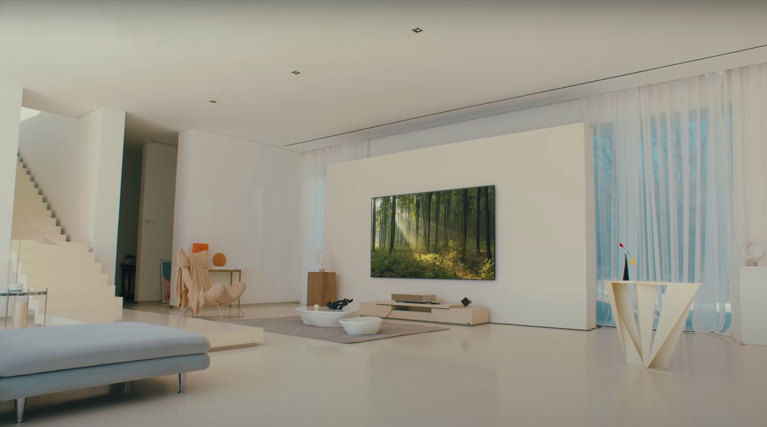 A modern lounge space with TV mounted on wall. 