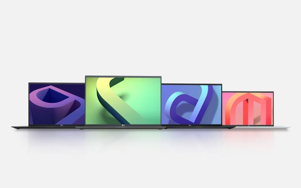 A row of four LG gram Laptops, each displaying a different colourful abstract design on their screens, arranged on a white surface with a light background.